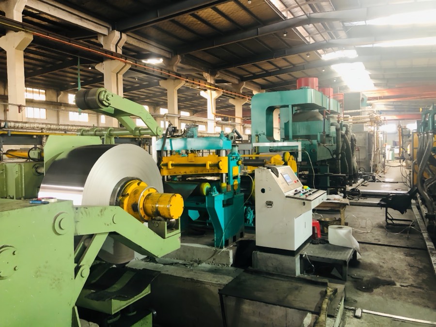 Strip rolling mill line with coil processing for precision nickel alloy strip