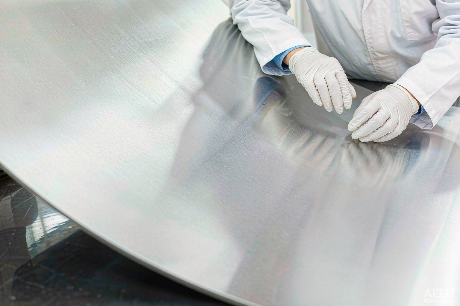 Close-up of a clean bright nickel alloy sheet surface inspected by a technician in white gloves in a quality control lab - Hangbo Alloy